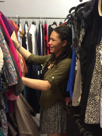 woman looks through second-hand clothes