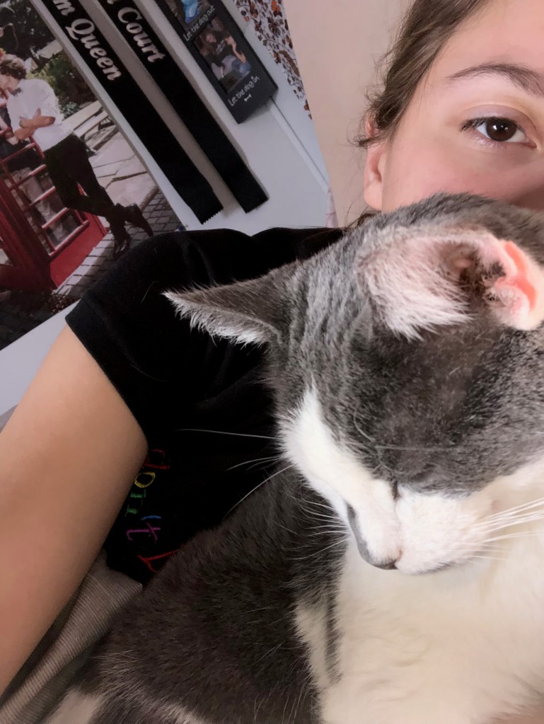 Staff Writer Jessica's cat Quasi cuddling with her.